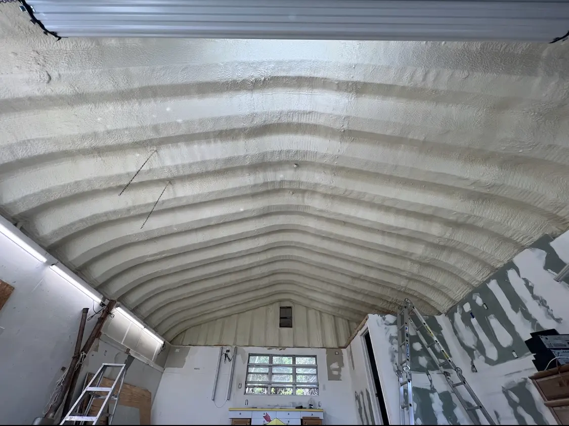 Spray polyurethane foam applied to the underside of a metal roof deck in Aptos